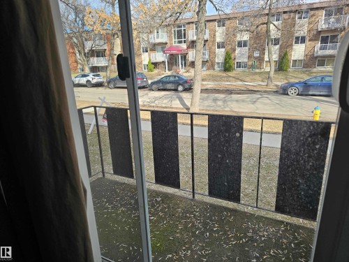 The property includes a balcony with black metal railings and a view of the street - 8 10616 123 Street, Edmonton, AB - Outdoor