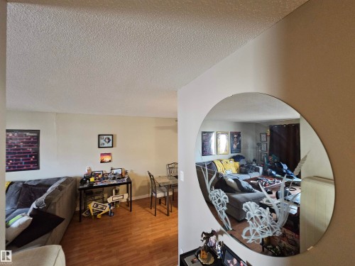 Living area featuring hardwood flooring and light-colored walls - 8 10616 123 Street, Edmonton, AB - Indoor