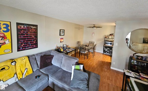 Living area featuring hard surface flooring and light-colored walls - 8 10616 123 Street, Edmonton, AB - Indoor Photo Showing Other Room
