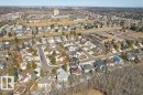 Aerial view highlighting the property within a residential neighborhood featuring established homes and mature trees - 17313 60 Avenue, Edmonton, AB  -  With View 