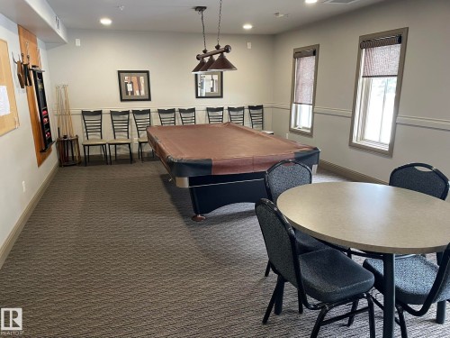 This property features a recreation room with a pool table, overhead lighting, and two windows - Edmonton, AB - Indoor