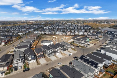 Aerial view of the property and surrounding neighborhood, featuring a residential area with a lake - 12 Dalquist Bay, Leduc, AB - Outdoor With View