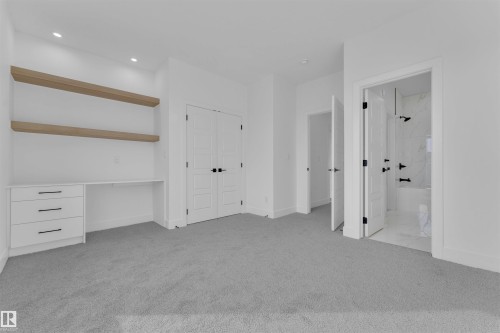 This room features light grey carpeting, recessed lighting, and a built-in desk area with three drawers and two wooden shelves - 12 Dalquist Bay, Leduc, AB - Indoor Photo Showing Other Room
