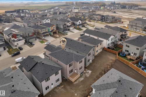 Aerial view of the property and surrounding neighborhood, featuring a newly constructed deck and a spacious undeveloped yard - 12 Dalquist Bay, Leduc, AB - Outdoor With View