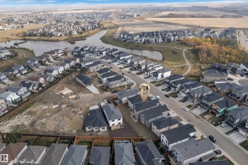 Aerial view of the property and its surrounding neighborhood, featuring a pond and established residential areas - 12 Dalquist Bay, Leduc, AB - Outdoor With View