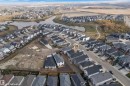 Aerial view of the property and its surrounding neighborhood, featuring a pond and established residential areas - 12 Dalquist Bay, Leduc, AB  - Outdoor With View 