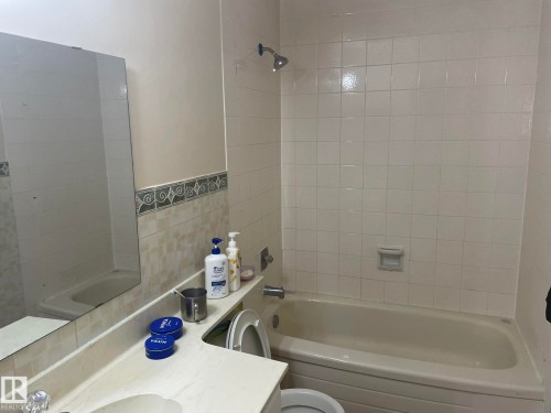 Bathroom featuring a white subway tile shower surround and a built-in tub - 9320 175 Street, Edmonton, AB - Indoor Photo Showing Bathroom