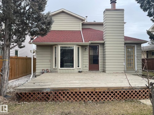 Expansive rear deck with lattice skirting, bay window, and two exterior access doors - 9320 175 Street, Edmonton, AB - Outdoor