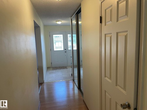 Inviting entryway featuring light-toned walls, hardwood flooring, and a front door with decorative glass inserts - 9320 175 Street, Edmonton, AB - Indoor Photo Showing Other Room