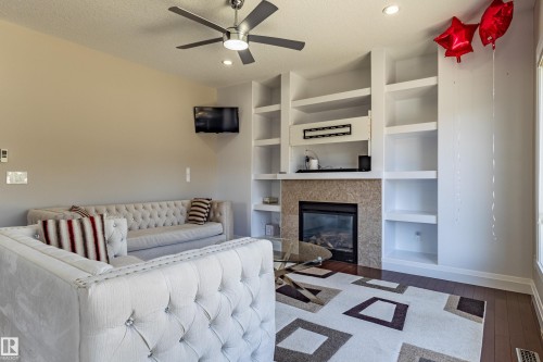 Living area featuring a ceiling fan with light, recessed lighting, and rich hardwood flooring - 3611 14 Street, Edmonton, AB - Indoor With Fireplace