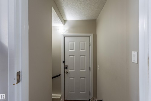The property features a white paneled door with dark hardware and light-colored walls - 3611 14 Street, Edmonton, AB - Indoor Photo Showing Other Room