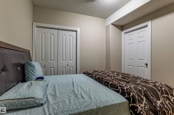 Room with light-colored walls, featuring a white paneled door and bi-fold closet doors - 