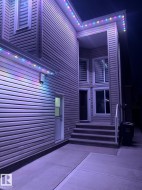 Property exterior featuring horizontal siding, a white entry door, and concrete steps leading to the main entrance - 