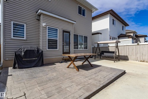 The property features a patio with stone pavers, a wooden privacy fence, and vinyl siding - 3611 14 Street, Edmonton, AB - Outdoor With Exterior