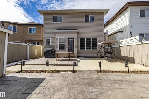 The property features a spacious backyard with a stamped concrete patio and a paved area - 3611 14 Street, Edmonton, AB - Outdoor With Exterior