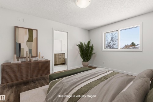 The room features wood flooring, a window providing natural light, and a ceiling light fixture - 3668 31A Street, Edmonton, AB - Indoor Photo Showing Bedroom