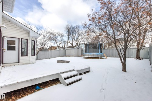The property features a spacious backyard with a deck and a privacy fence - 3668 31A Street, Edmonton, AB - Outdoor