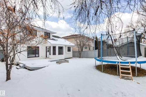 The property features a white exterior, a deck, and an extensive yard - 3668 31A Street, Edmonton, AB - Outdoor