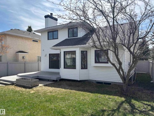 Rear exterior featuring a multi-level deck, white siding, and a fenced yard - 3668 31A Street, Edmonton, AB - Outdoor