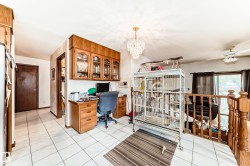 Tiled flooring with integrated desk space and built-in cabinetry - 