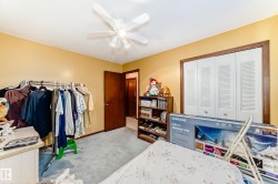 Room featuring soft yellow walls and a white ceiling fan - 