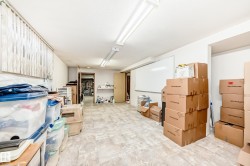 Basement space featuring recessed ceiling lighting, textured ceiling, and neutral-toned flooring - 