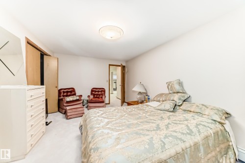 Carpeted bedroom with a sloped ceiling and light neutral wall finishes - 208 Willow Crescent, Wetaskiwin, AB - Indoor Photo Showing Bedroom