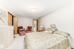 Carpeted bedroom with a sloped ceiling and light neutral wall finishes - 