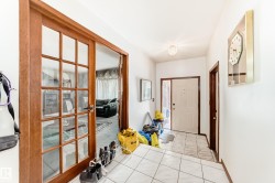 Foyer with ceramic tile flooring leading to a front entry door with sidelight - 