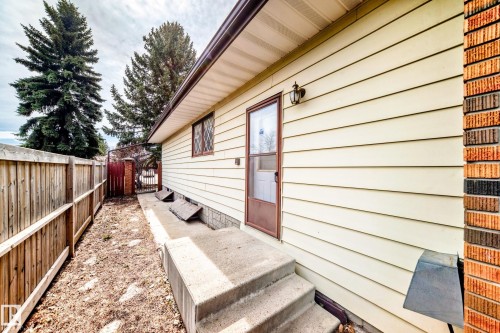 Exterior siding in a light neutral tone with brick accent column - 208 Willow Crescent, Wetaskiwin, AB - Outdoor With Exterior