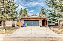 Brick facade residence featuring an attached double garage - 
