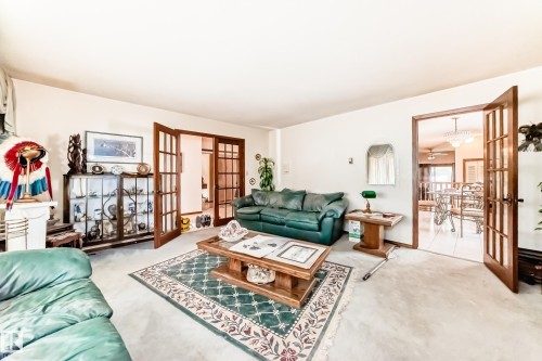 Spacious room featuring multiple doorways with French doors - 208 Willow Crescent, Wetaskiwin, AB - Indoor Photo Showing Living Room