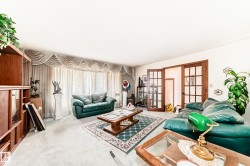 Spacious room featuring light-colored wall-to-wall carpeting and neutral wall paint - 
