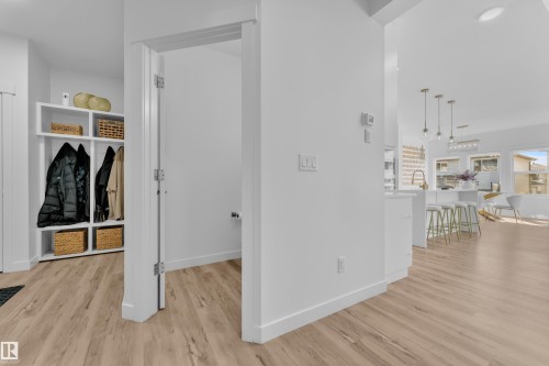 The property features light-toned flooring throughout, a built-in storage unit with shelving, and an open doorway leading to an additional space - 7815 174 Avenue, Edmonton, AB - Indoor Photo Showing Other Room