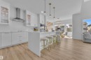 This bright open-concept living space features light-toned flooring, white walls, and abundant natural light from several windows - 7815 174 Avenue, Edmonton, AB  - Indoor Photo Showing Kitchen 