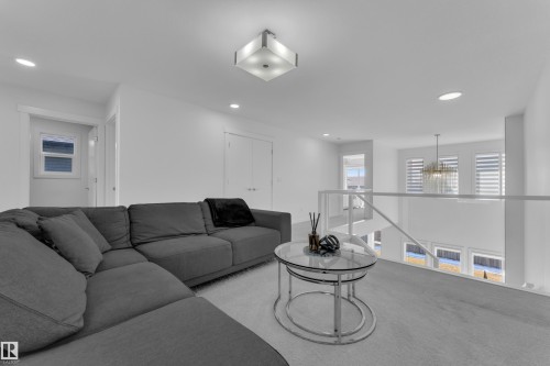 This open concept space features white walls, recessed lighting, and a modern ceiling light fixture - 7815 174 Avenue, Edmonton, AB - Indoor Photo Showing Living Room