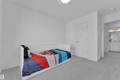 This room features light gray carpeting, white walls, and a closet with double doors - 7815 174 Avenue, Edmonton, AB - Indoor Photo Showing Bedroom