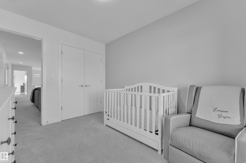 Bedroom featuring a neutral wall color, light-colored carpeting, and a white closet with double doors - 7815 174 Avenue, Edmonton, AB - Indoor Photo Showing Bedroom
