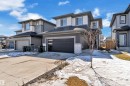 The property features a contemporary exterior with multi-toned siding, a two-car garage with frosted glass panels, and a concrete driveway - 7815 174 Avenue, Edmonton, AB  - Outdoor With Facade 