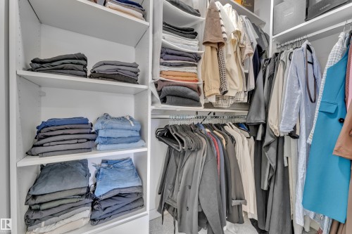 The property features a spacious walk-in closet with built-in shelving and hanging rods - 7815 174 Avenue, Edmonton, AB - Indoor With Storage