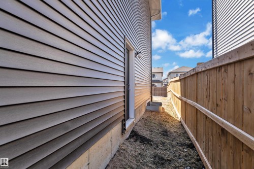 The property features a wood fence and light-colored siding on the exterior - 7815 174 Avenue, Edmonton, AB - Outdoor
