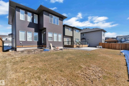 The property features a two-story exterior with horizontal siding and an expansive yard space - 7815 174 Avenue, Edmonton, AB - Outdoor With Exterior