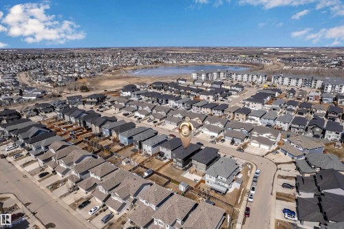 Aerial view of the property and its surrounding neighborhood, showcasing residential streets, detached homes, and a nearby body of water - 7815 174 Avenue, Edmonton, AB - Outdoor With View