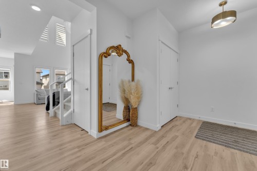 Entryway with light wood-style flooring, white walls, and a contemporary ceiling light fixture - 7815 174 Avenue, Edmonton, AB - Indoor Photo Showing Other Room