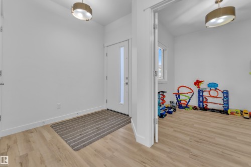 The property features light-colored flooring throughout, white walls, and contemporary ceiling light fixtures - 7815 174 Avenue, Edmonton, AB - Indoor Photo Showing Other Room