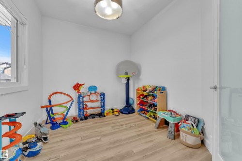 This room features light wood-style flooring, white walls, and a window providing natural light - 7815 174 Avenue, Edmonton, AB - Indoor Photo Showing Other Room
