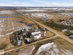 Property site featuring a single structure, established trees, and direct road frontage - 