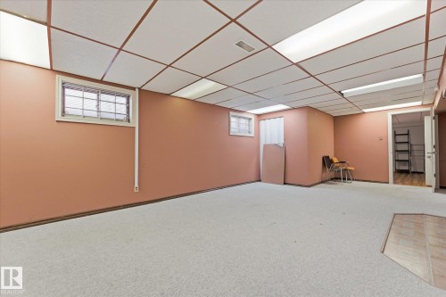 Spacious room featuring light-colored carpeting and a drop ceiling with integrated lighting - 25750 18 Street, Edmonton, AB - Indoor