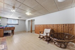 Finished lower level featuring light wood-finish flooring and a drop ceiling with recessed lighting - 
