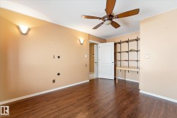 Wood-finish flooring throughout, complemented by a ceiling fan with integrated lighting - 